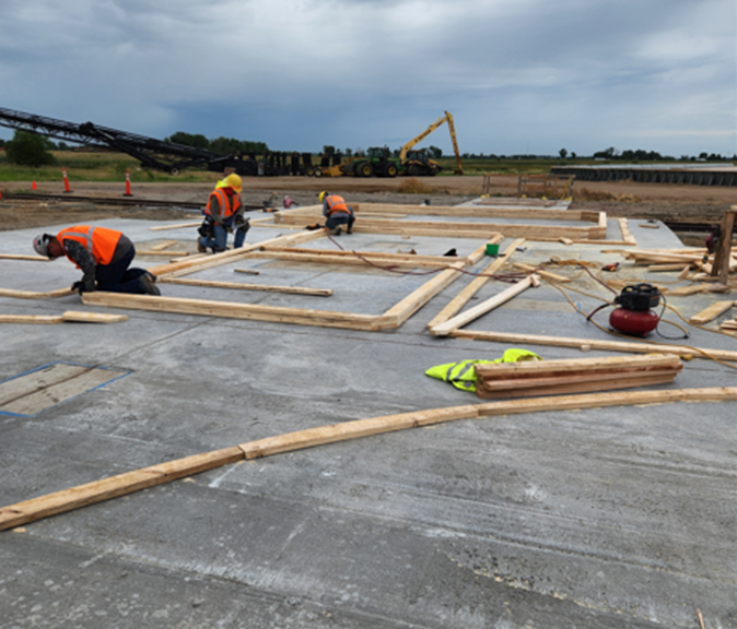 View of construction workers working on forms for bins