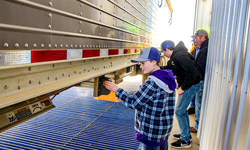 boy looking at a semi