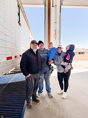 a family standing in a new grain facility